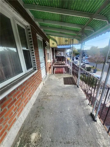 a view of a porch with wooden floor