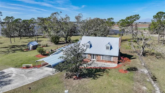 an aerial view of a house with a yard