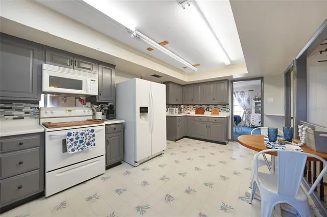 a kitchen with stainless steel appliances a refrigerator sink and cabinets