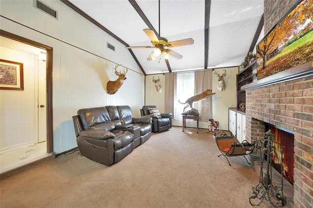 a living room with furniture a fireplace and window