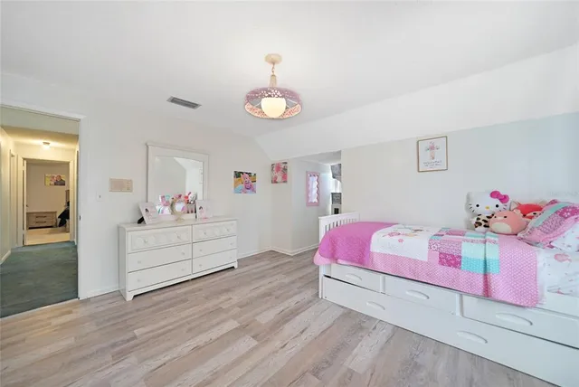 a bedroom with a bed and a dresser