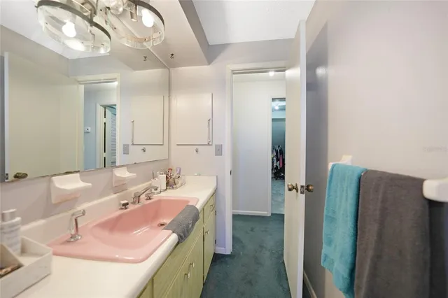 a bathroom with a granite countertop sink a large mirror and a shower