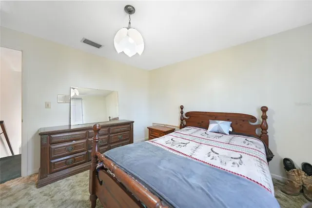 a bed room with a bed and a chandelier