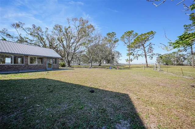 a view of a house with backyard and porch