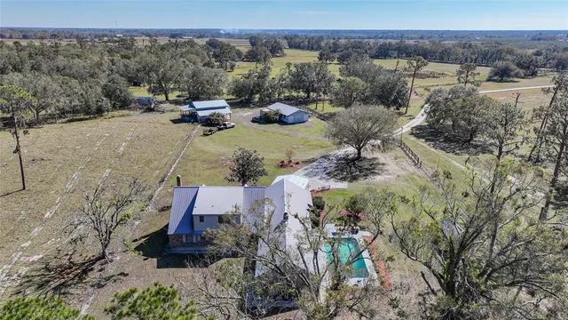 an aerial view of a house with outdoor space and lake view