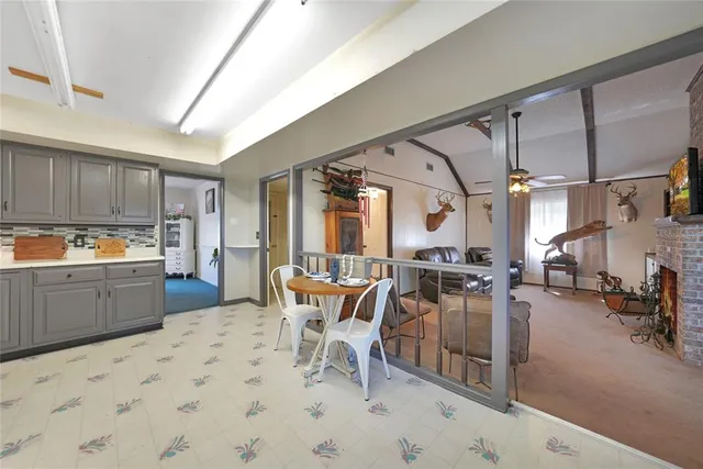 a kitchen with stainless steel appliances kitchen island granite countertop a sink and cabinets