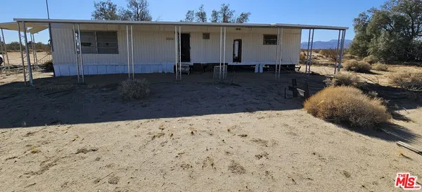a view of house with backyard and seating space