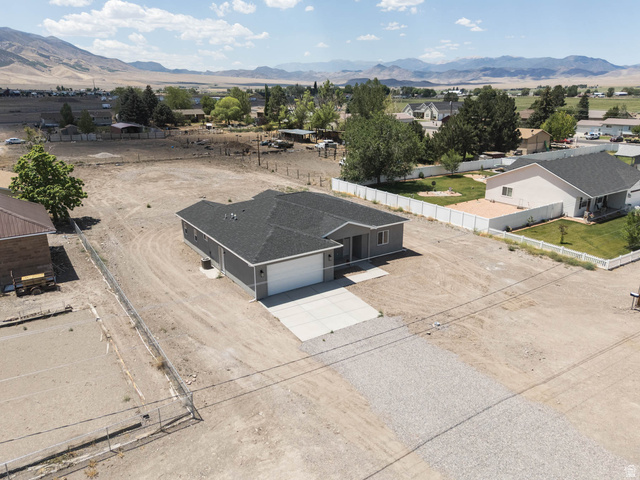 51 West 500 South Monroe, UT 84754 - Photo 1 of 41 Contemporary single-story residence featuring a dark gray exterior, a two-car garage with a white door, and a paved concrete driveway