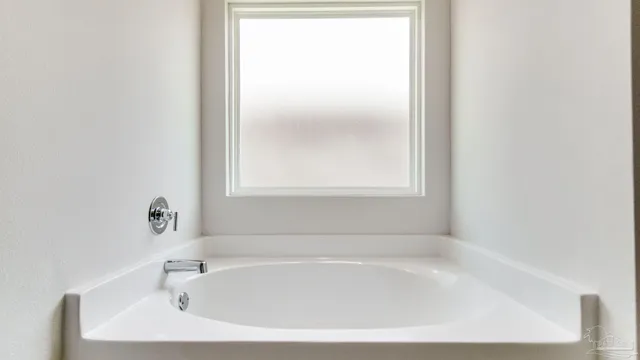 a white bath tub sitting next to a window