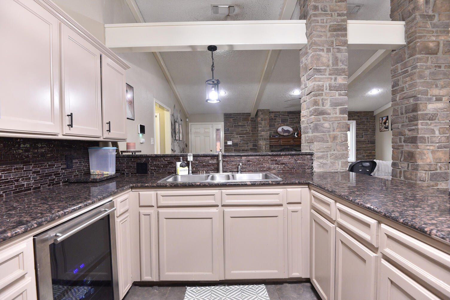 5202 93rd Street Lubbock, TX 79424 - Photo 11 of 28 a kitchen with granite countertop a sink and cabinets