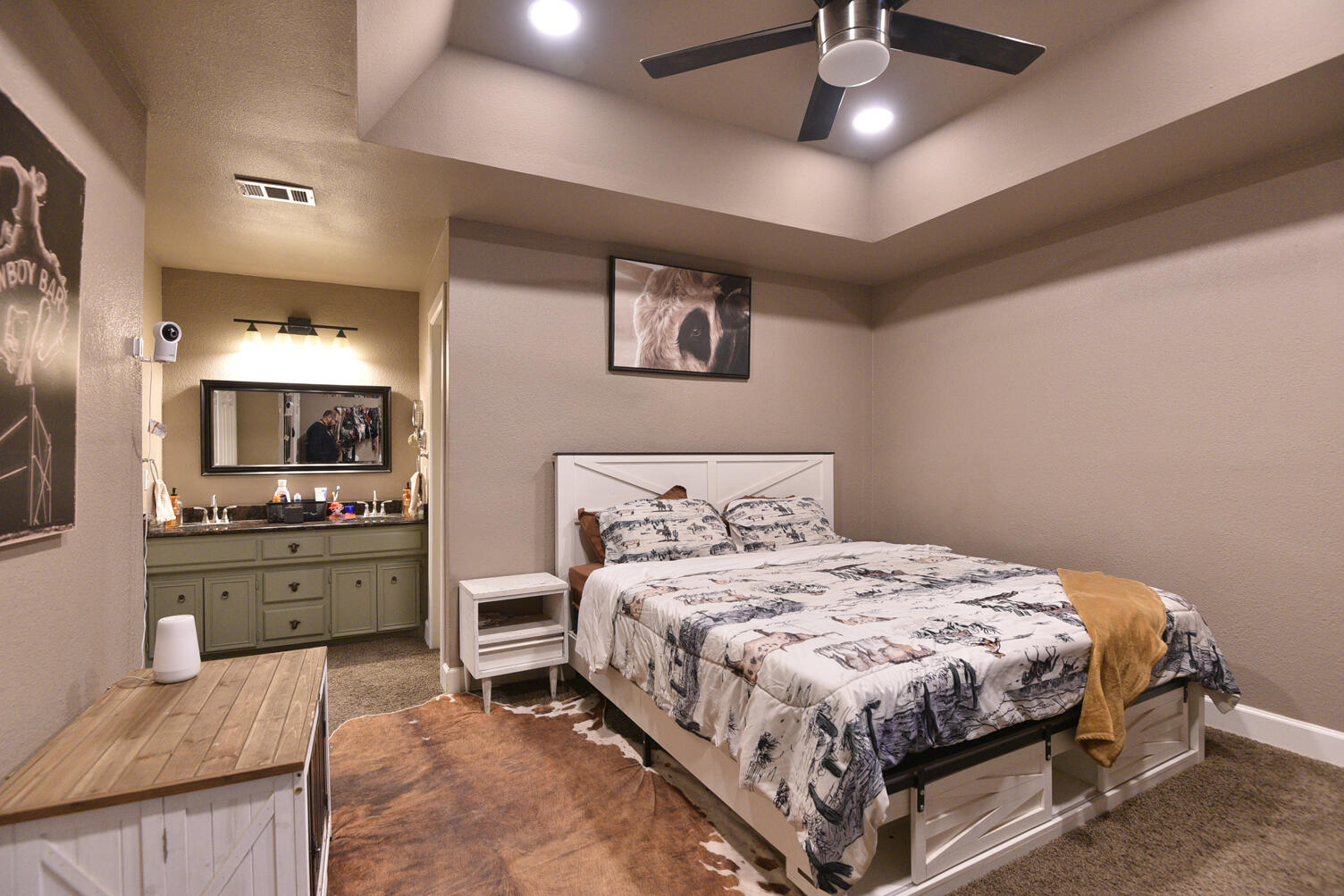 5202 93rd Street Lubbock, TX 79424 - Photo 14 of 28 a bedroom with a large bed and a chandelier