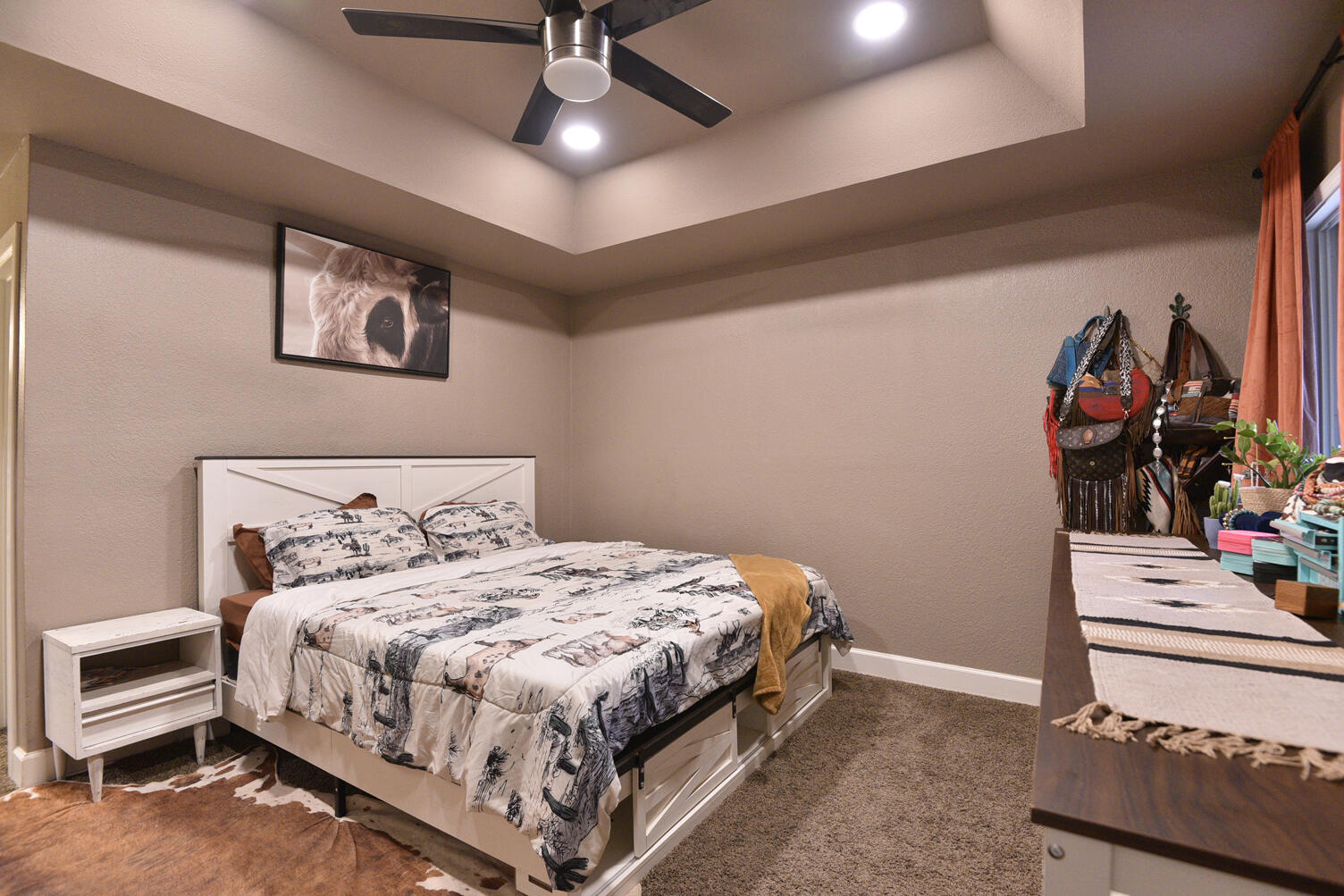 5202 93rd Street Lubbock, TX 79424 - Photo 15 of 28 a bedroom with a bed and a chandelier