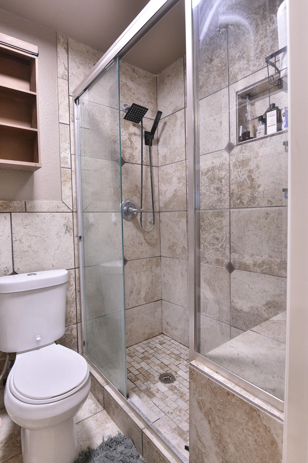5202 93rd Street Lubbock, TX 79424 - Photo 18 of 28 a bathroom with a toilet and a shower