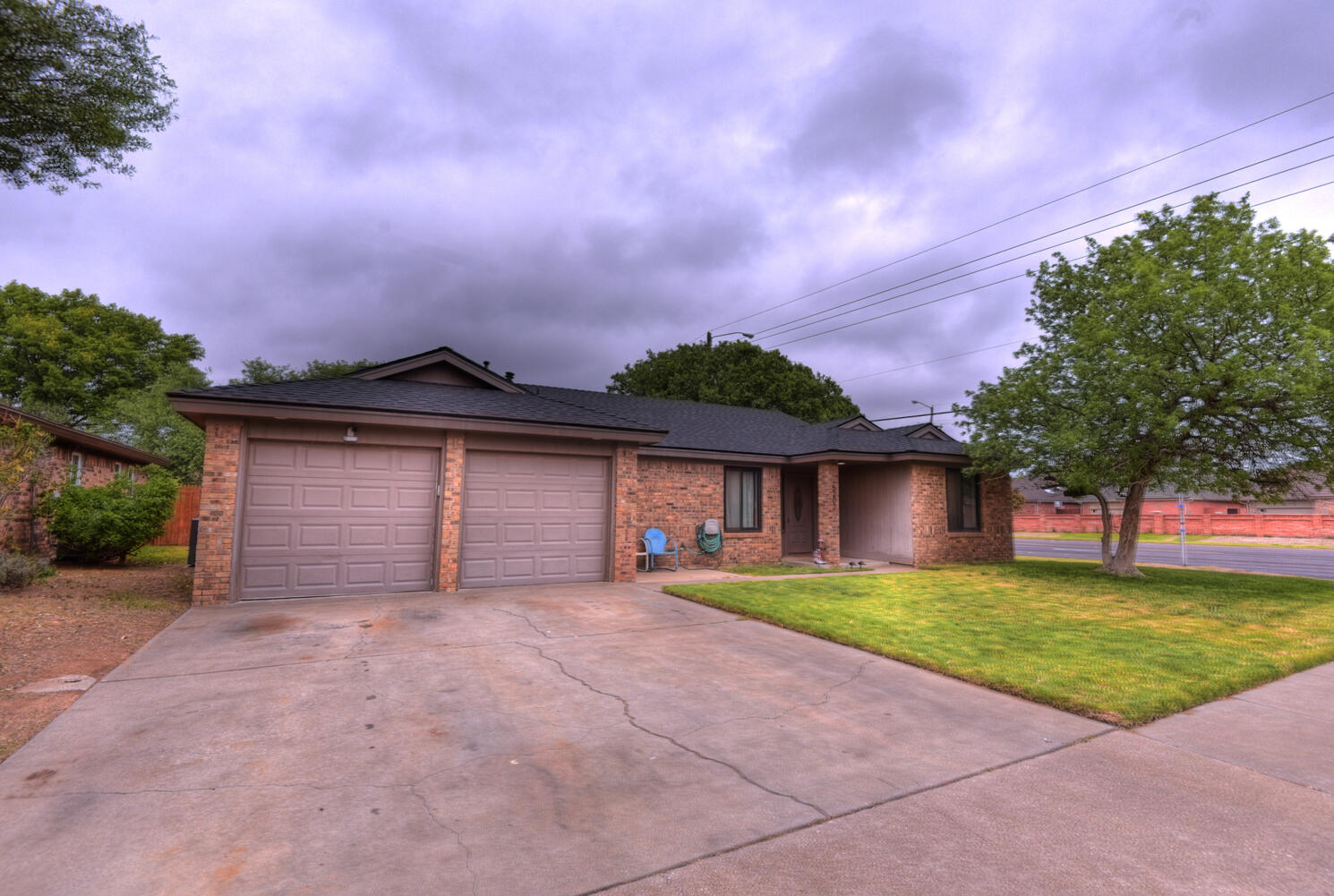 5202 93rd Street Lubbock, TX 79424 - Photo 2 of 28 a front view of a house with a yard and garage