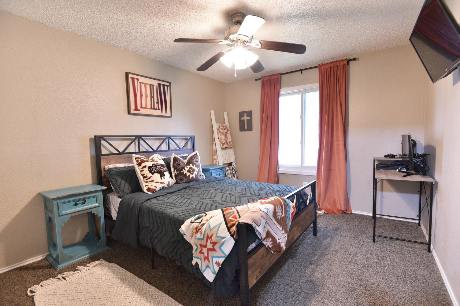 5202 93rd Street Lubbock, TX 79424 - Photo 22 of 28 a bed sitting in a bedroom next to a window