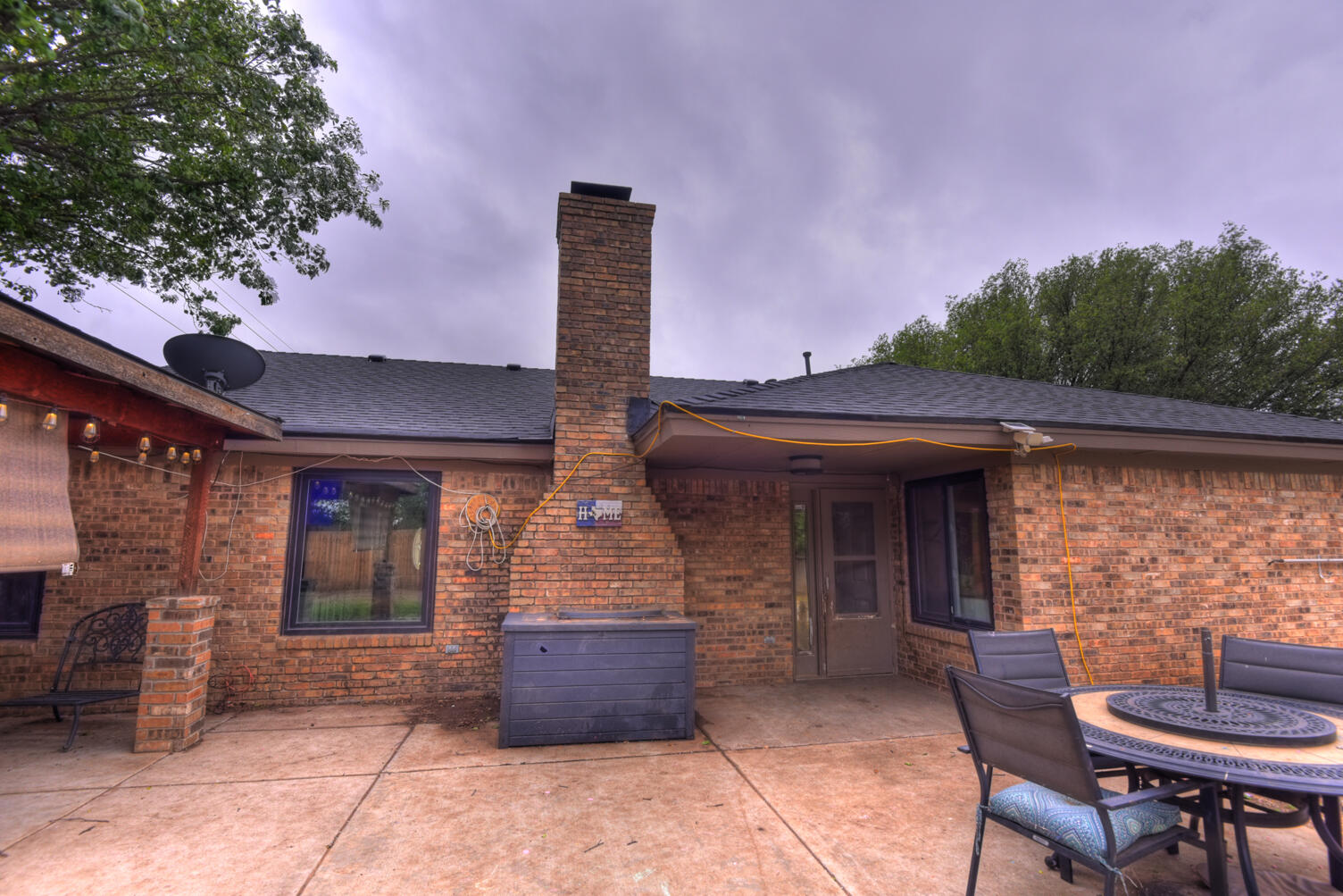 5202 93rd Street Lubbock, TX 79424 - Photo 27 of 28 a front view of a house with outdoor seating and barbeque oven