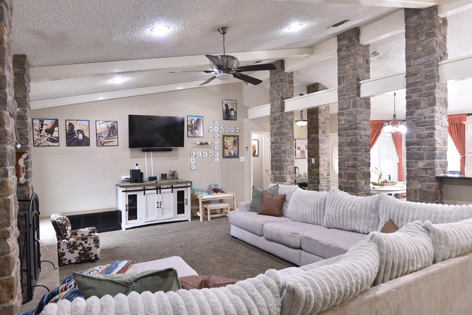 5202 93rd Street Lubbock, TX 79424 - Photo 4 of 28 a living room with furniture a flat screen tv and a large window