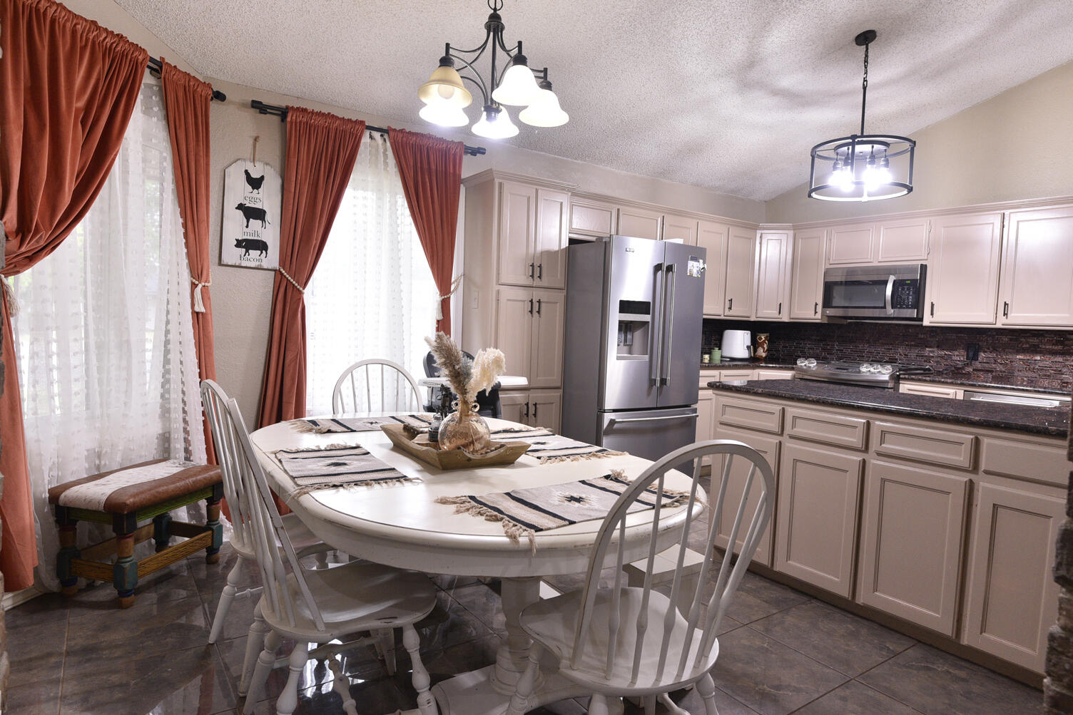 5202 93rd Street Lubbock, TX 79424 - Photo 7 of 28 a view of a dining room with furniture window and wooden floor