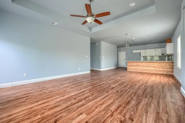 a view of an empty room and wooden floor