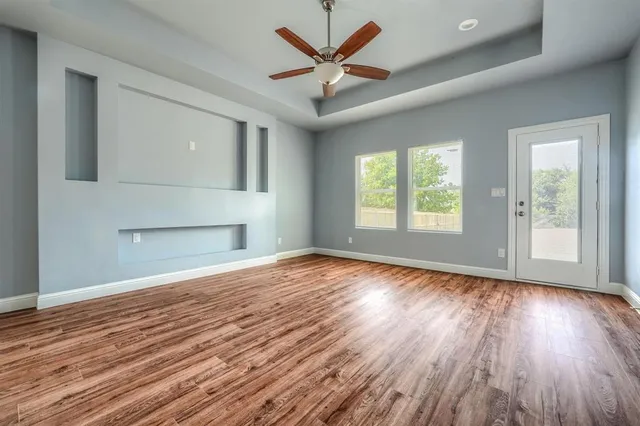 wooden floor in an empty room with a window