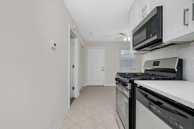 a kitchen with stainless steel appliances a stove a microwave and cabinets