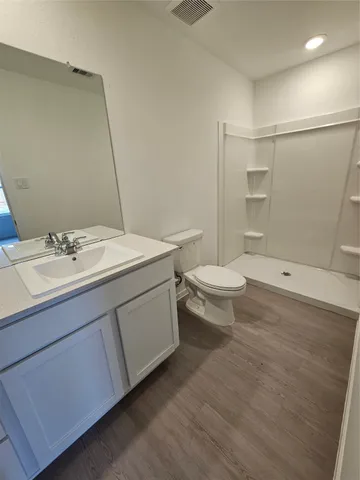 a bathroom with a tub sink and vanity