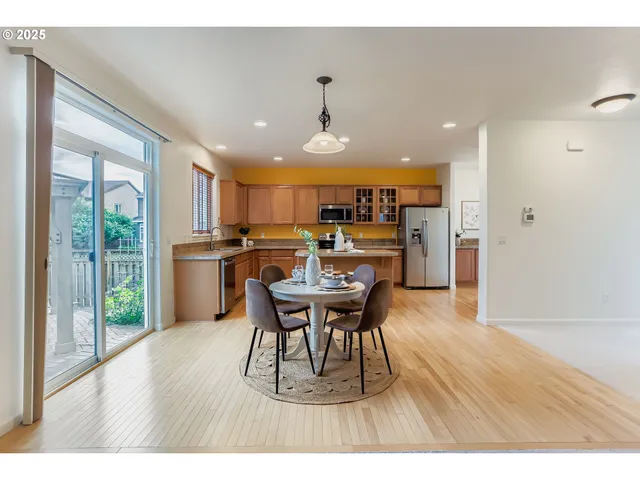 a dining room with furniture and wooden floor