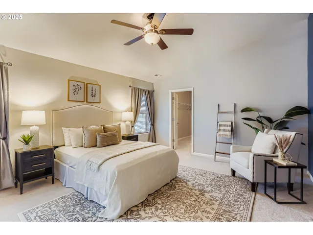 a bedroom with a large bed and a chandelier