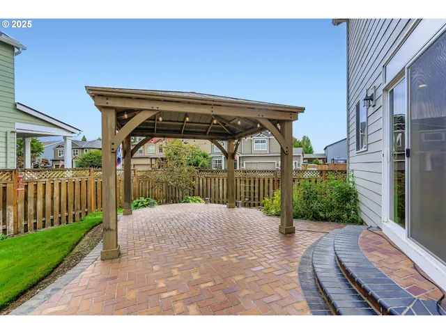 a view of an house with backyard and a patio