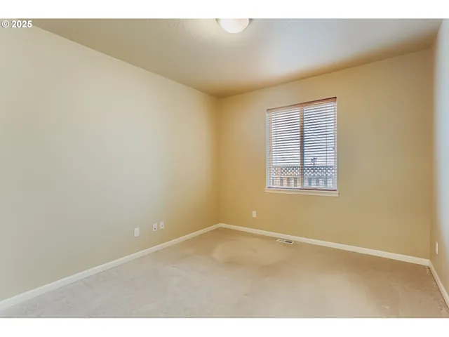 an empty room with a empty space and a window