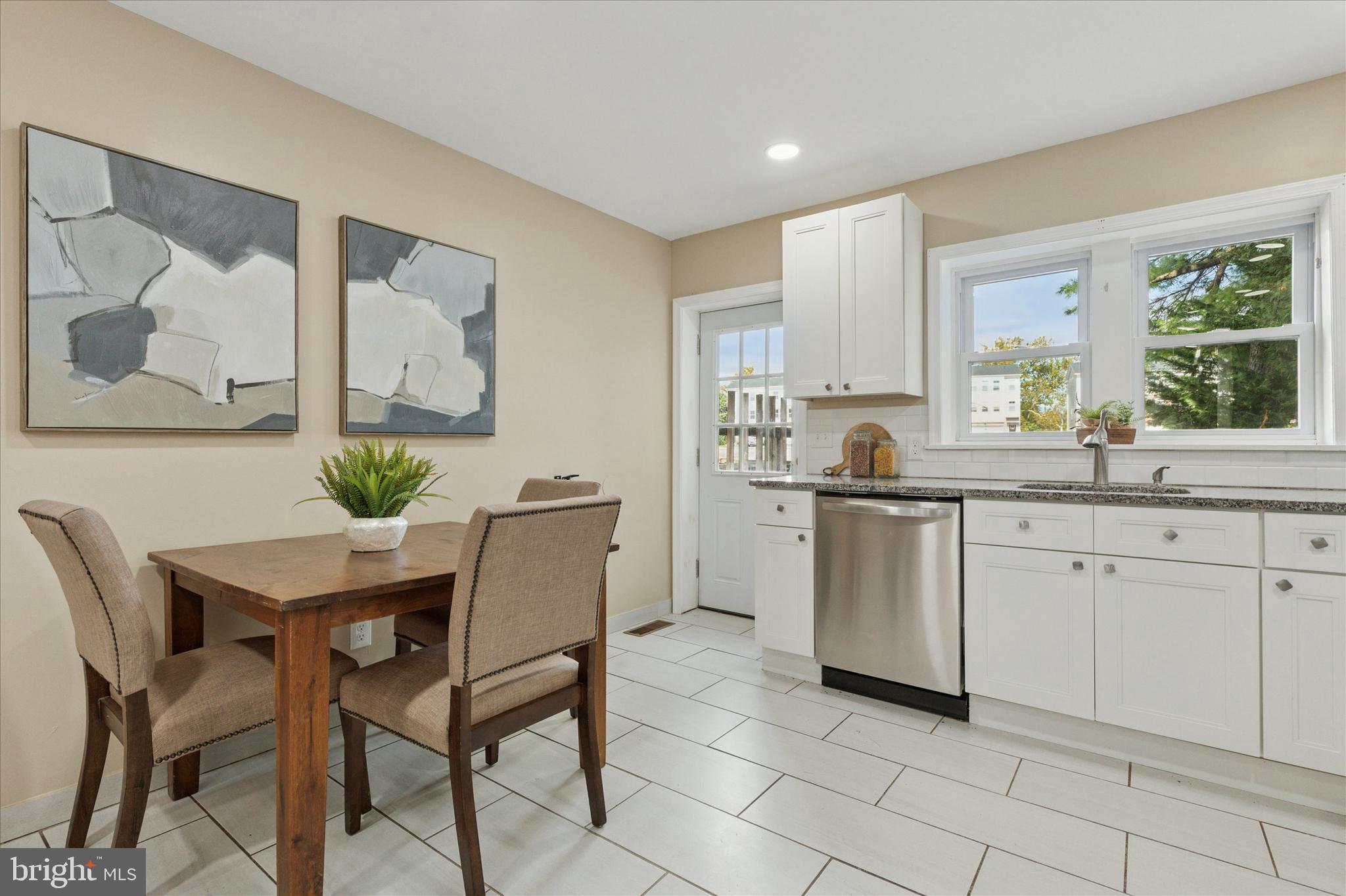 39 West Front Street Bridgeport, PA 19405 - Photo 11 of 23 a kitchen with a dining table chairs and cabinets