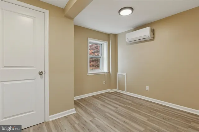 an empty room with wooden floor and closet