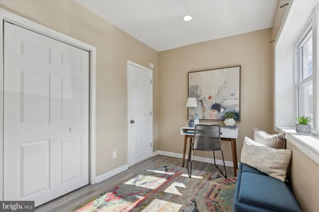 a workspace with wooden floor and a rug