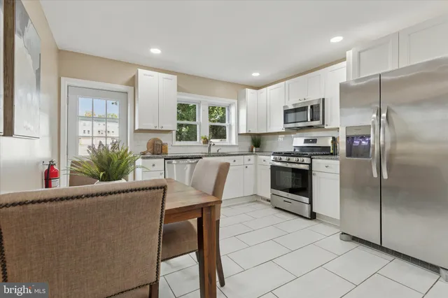 a kitchen with sink a microwave and refrigerator