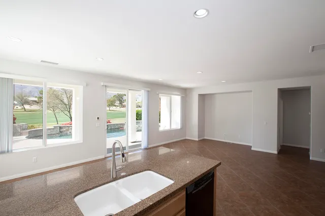 a room with a window wooden floor and a sink