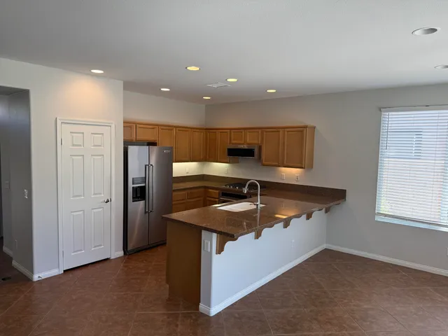 a kitchen that has a sink and a refrigerator