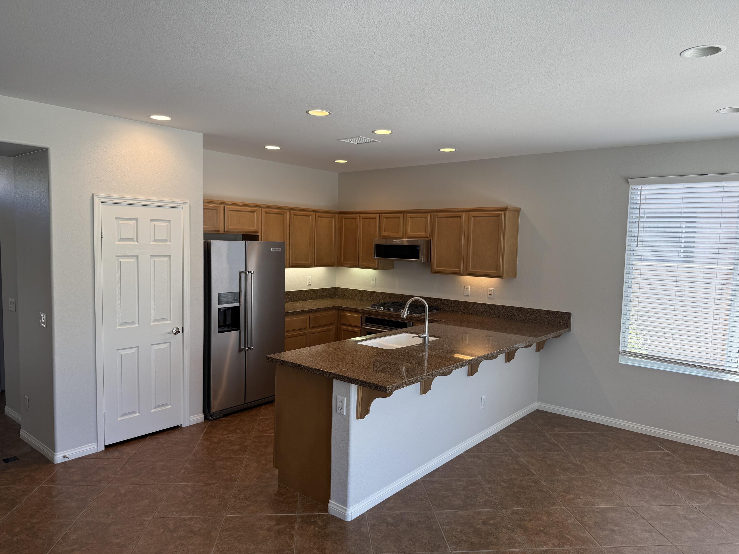 81237 Red Rock Road La Quinta, CA 92253 - Photo 6 of 21 a kitchen that has a sink and a refrigerator