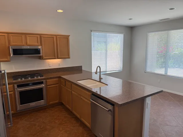 a kitchen that has a sink and a stove in it