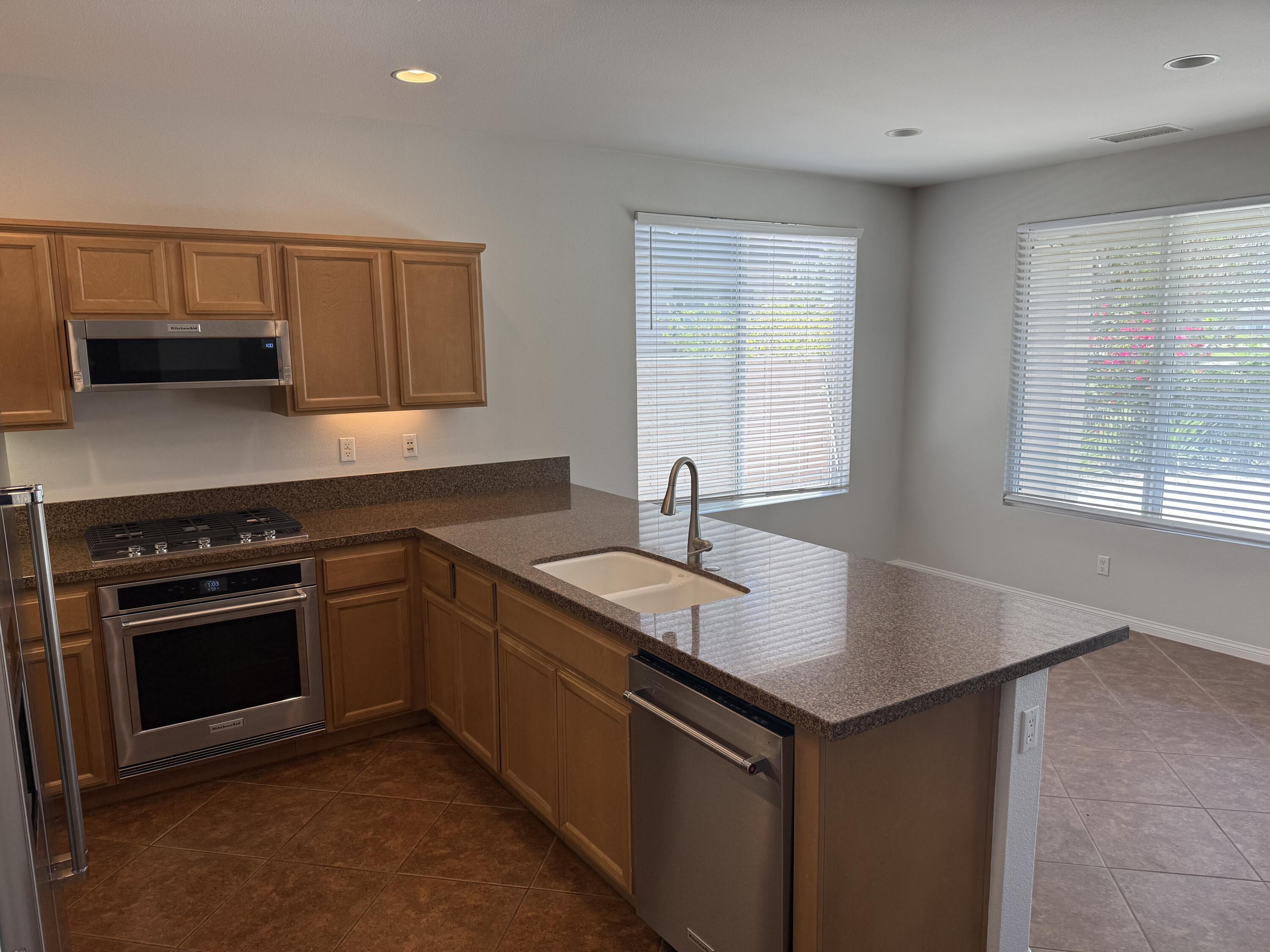 81237 Red Rock Road La Quinta, CA 92253 - Photo 8 of 21 a kitchen that has a sink and a stove in it