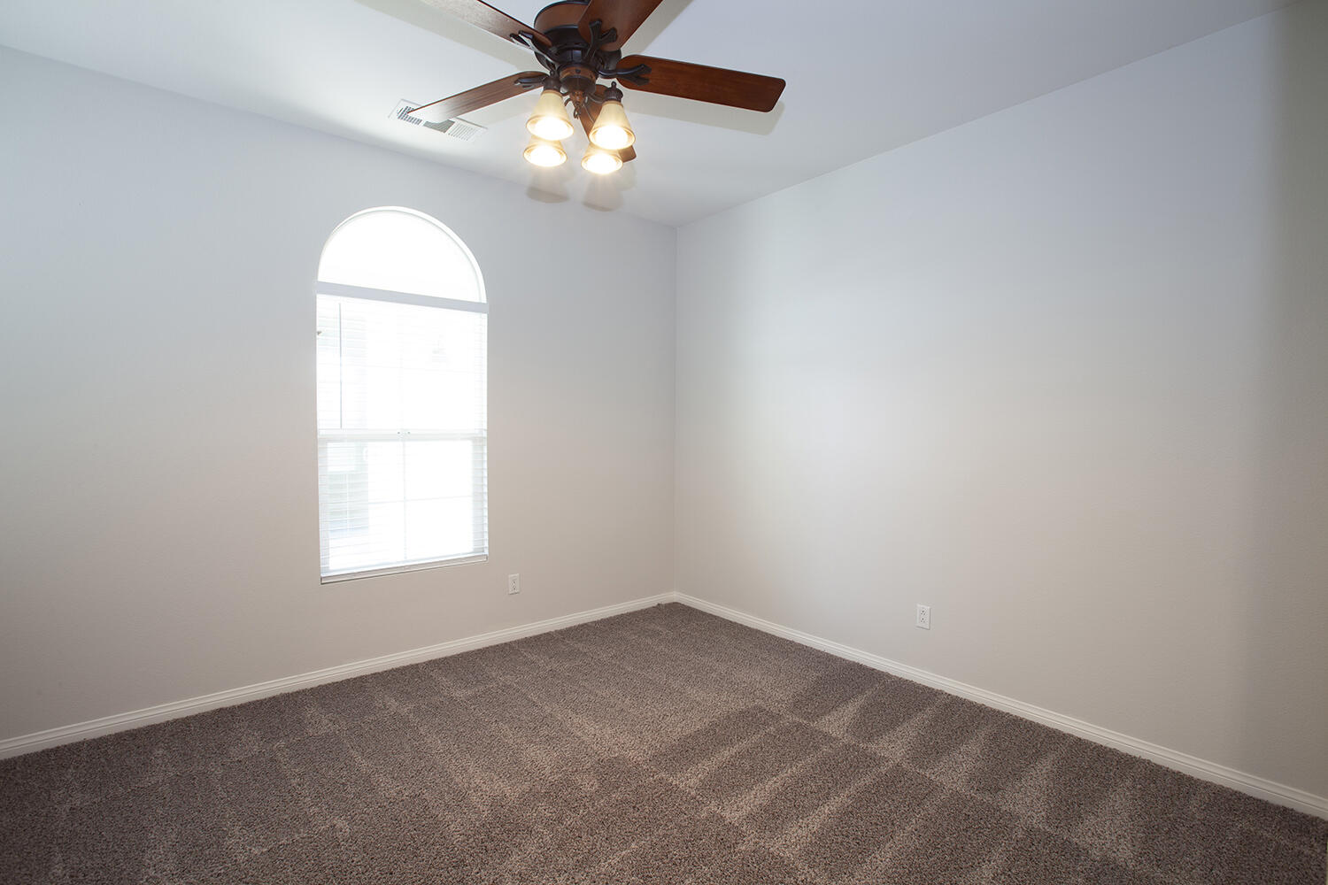 81237 Red Rock Road La Quinta, CA 92253 - Photo 9 of 21 an empty room with windows and chandelier fan