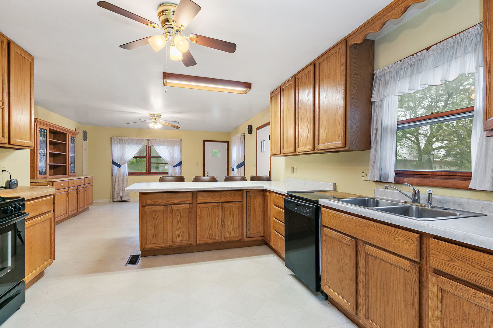 148 Holly Street DeKalb, IL 60115 - Photo 12 of 27 a kitchen with stainless steel appliances granite countertop a sink a stove cabinets and wooden floor