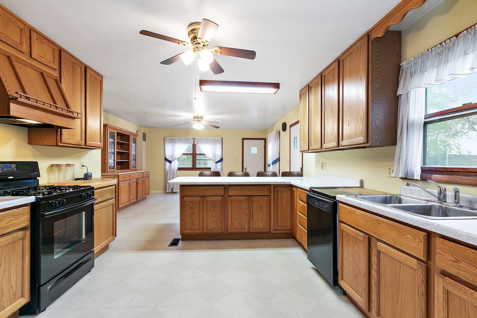 148 Holly Street DeKalb, IL 60115 - Photo 13 of 27 a kitchen with stainless steel appliances granite countertop a stove top oven a sink a counter space and cabinets