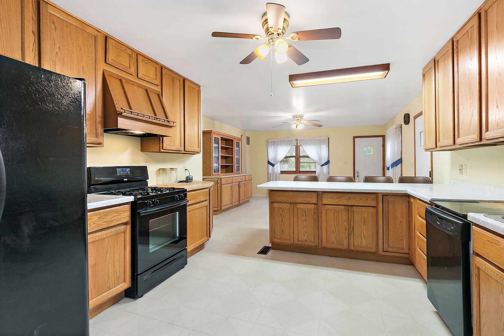 148 Holly Street DeKalb, IL 60115 - Photo 14 of 27 a large kitchen with stainless steel appliances granite countertop a stove a sink dishwasher and a refrigerator