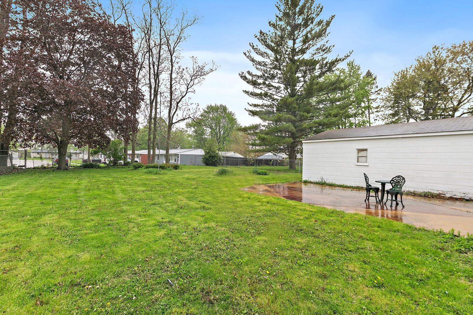 148 Holly Street DeKalb, IL 60115 - Photo 23 of 27 a view of a backyard with a table and chairs