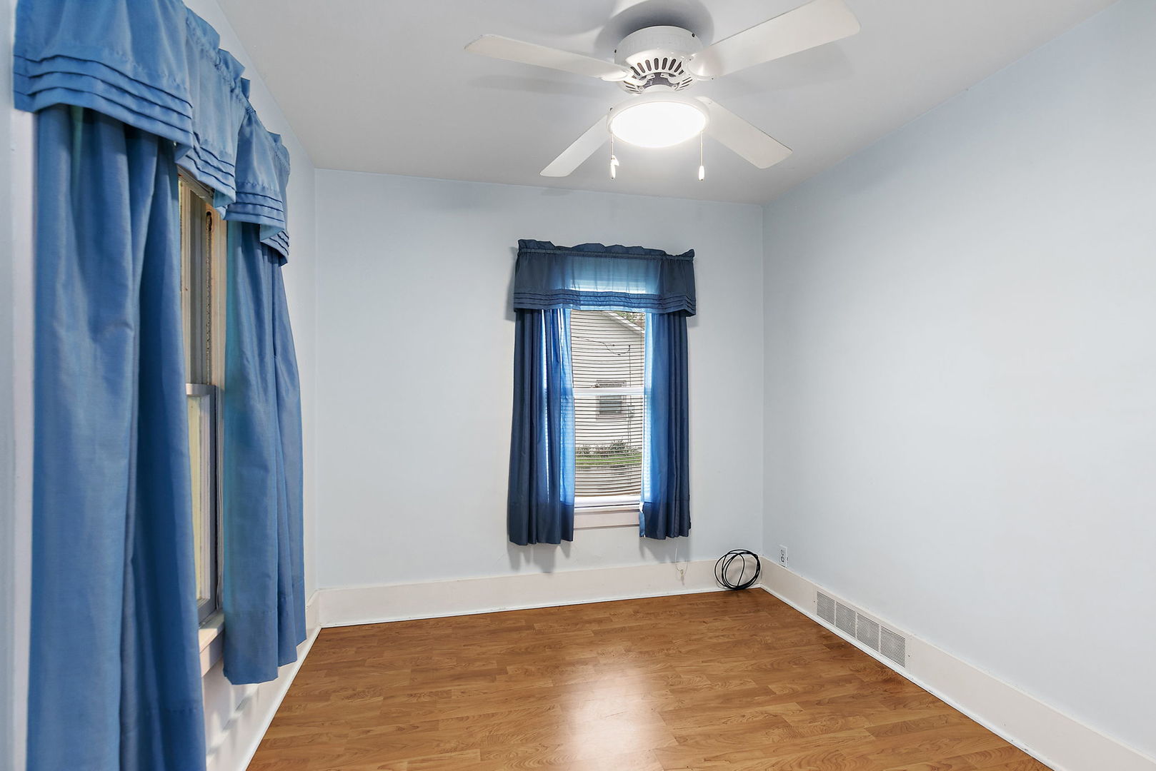 148 Holly Street DeKalb, IL 60115 - Photo 6 of 27 a view of an empty room with window and chandelier fan