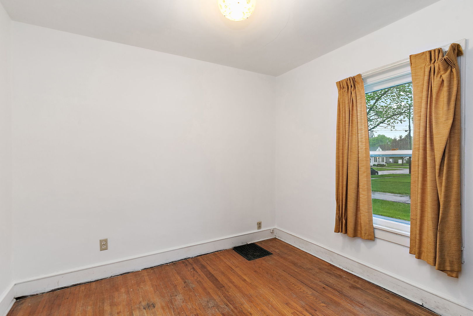 148 Holly Street DeKalb, IL 60115 - Photo 10 of 27 an empty room with wooden floor and windows