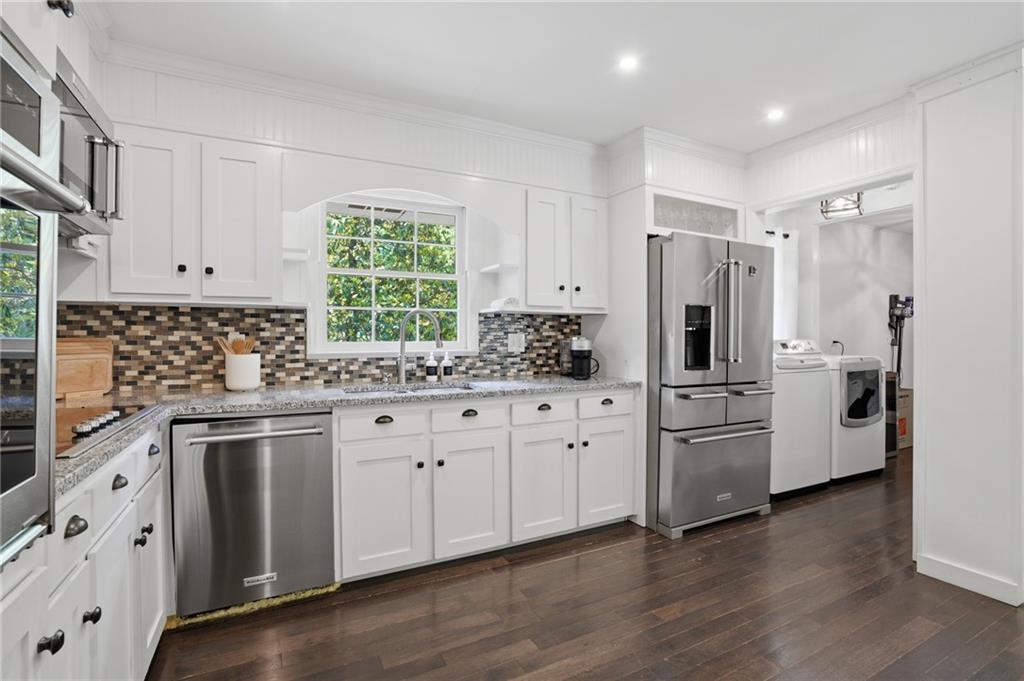 4000 Lower Roswell Road Marietta, GA 30068 - Photo 10 of 25 a kitchen with stainless steel appliances white cabinets and wooden floors