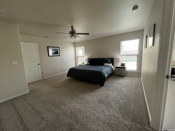 a living room with a bed furniture and a window