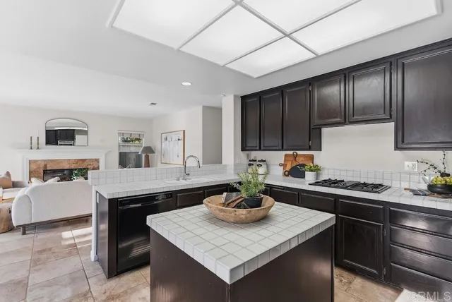 a kitchen with a sink a stove and cabinets