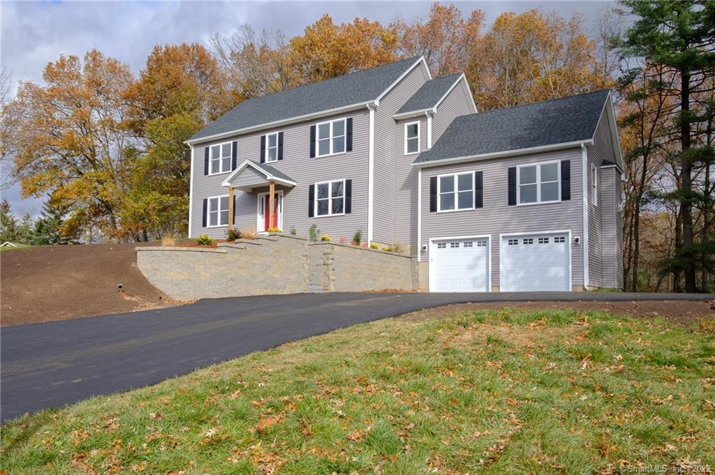 28 Wells Road Ellington, CT 06029 - Photo 1 of 1 a front view of a house with a yard and garage
